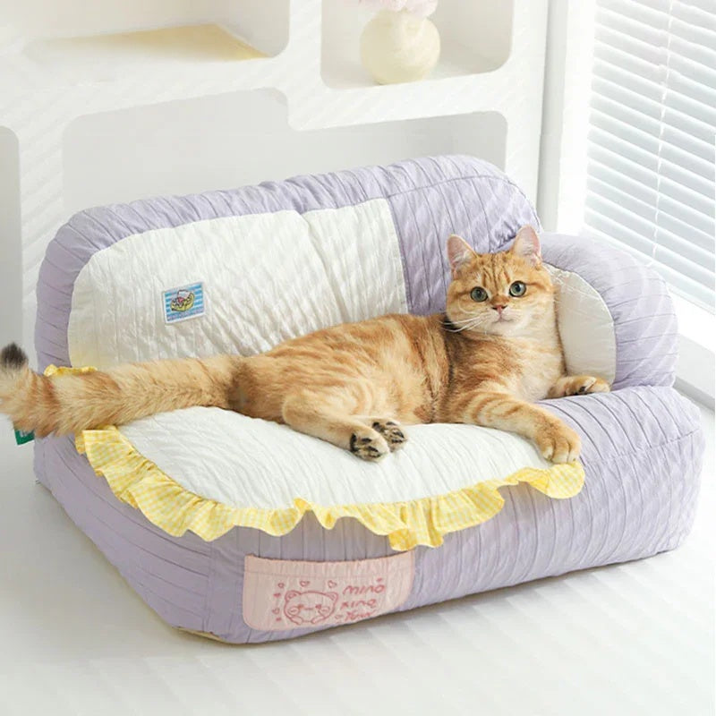 Soft & Cozy Cat Sofas β Perfect Lounging Spots for Happy Indoor Cats with a happy cat lounging on a plush sofa.