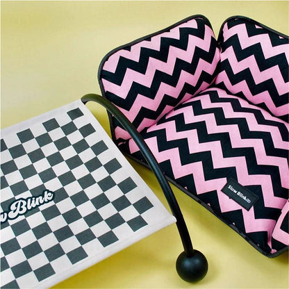 Memphis-Style Elevated Cat Hammock & Woven Wool Cat Cave with pink and black zigzag pattern and checkered base.