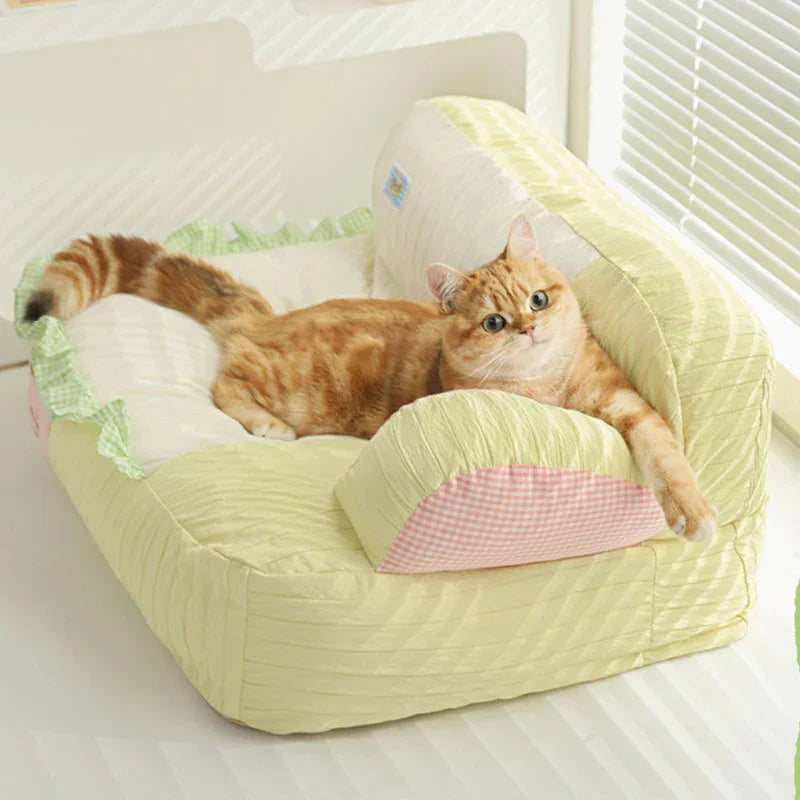 Soft & Cozy Cat Sofas — Perfect Lounging Spots for Happy Indoor Cats with a relaxed orange tabby lounging on a green and white sofa.