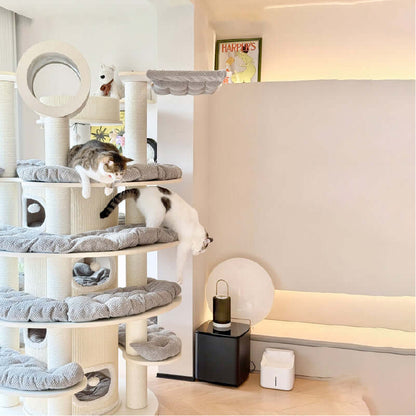 Cats playing on a Luxury Multi-Level Cat Tower for Indoor Cats, featuring cozy resting areas and climbing levels.