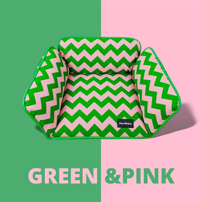 Green and pink zigzag cat bed with a cozy design for pets.