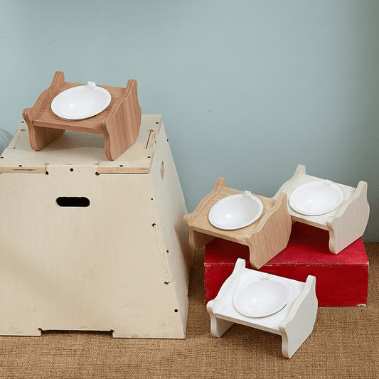 KtKitty Elevated Slanted Wooden Cat Bowl Stand with ceramic bowls.  The 15-degree tilted design promotes healthy digestion and neck protection for cats.