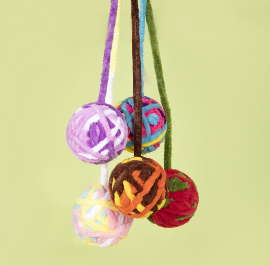 Interactive yarn ball cat toy with bell, designed for kitten play and teething.