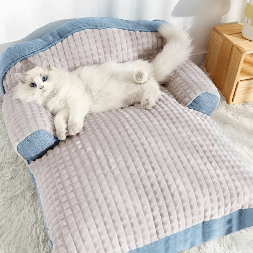 A massive Ragdoll cat stretching out comfortably on an ergonomic large cat sofa bed with thick PP cotton padding for superior winter insulation.