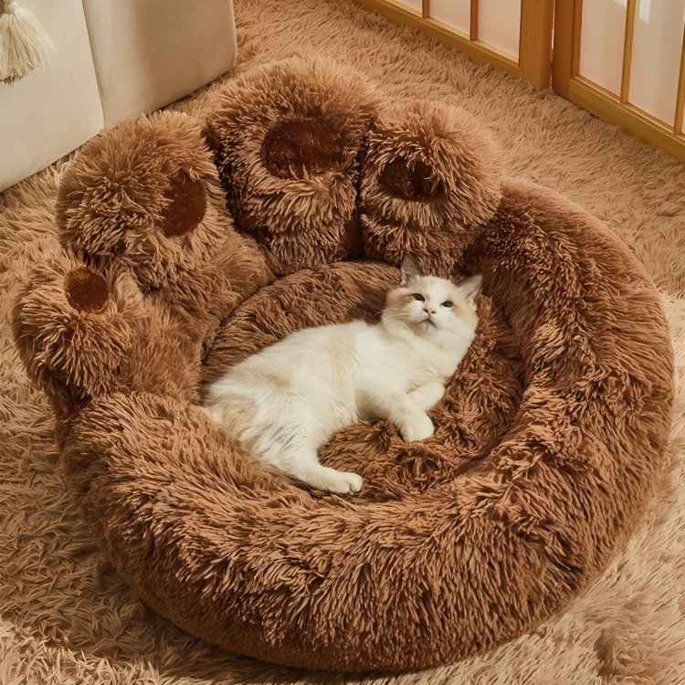 A soft Ragdoll cat lounging in a brown paw-shaped plush cat bed, highlighting the ultra-soft long-pile fabric and self-warming winter comfort.