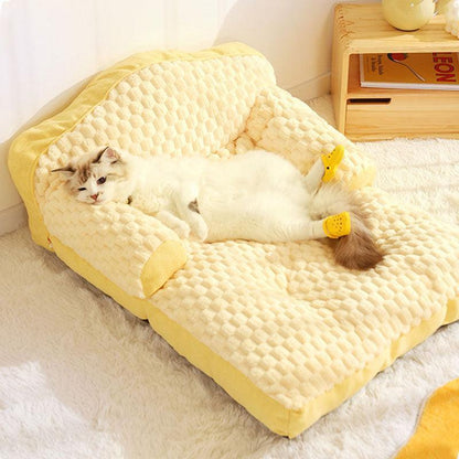 Cat enjoying the warmth and space of the large sofa.