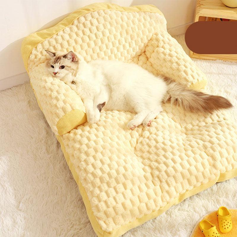 A cat lounging on the large space sofa in a cozy position.