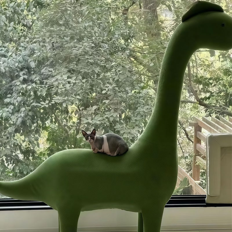 Cushioned landing pad on dinosaur cat tree for post-play rest
