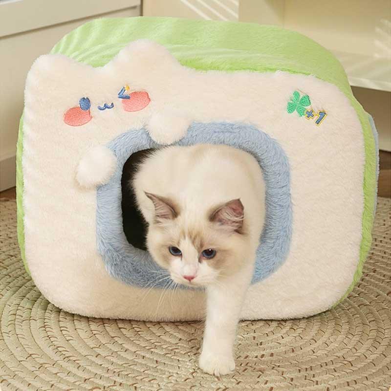 Warm Two-Color Cat Bed Cave – Cozy & Safe Hideaway for Your Cat with a playful cat exploring its entrance.
